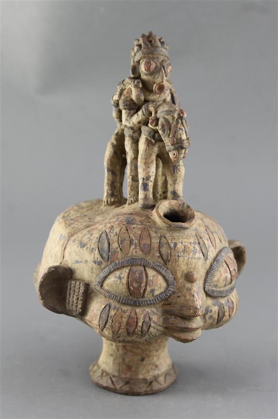 An Ibo People of Nigeria terracotta vessel, in the form of anthropomorphic head with very large eyes, height 34cm